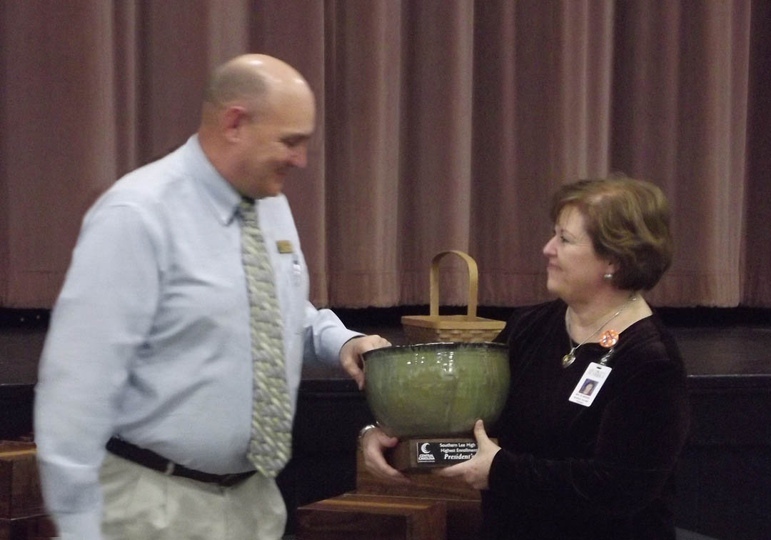 Click to enlarge,  Dr. Stephen Athans (left), Central Carolina Community College's Dean of Vocational and Technical Programs, presents the college's 2013 President's Cup to Southern Lee High School Principal Bonnie Almond during the college's Feb. 8 Information and Planning Conference luncheon at the Dennis A. Wicker Civic Center. The cup is presented annually to the high school in the college's service area of Chatham, Harnett and Lee counties that has the highest percentage of the previous year's graduates continuing their education at CCCC. Southern Lee had 17.52 percent of its graduating students enroll at the college. For more information about programs at Central Carolina Community College, visit its Web site, www.cccc.edu. 
