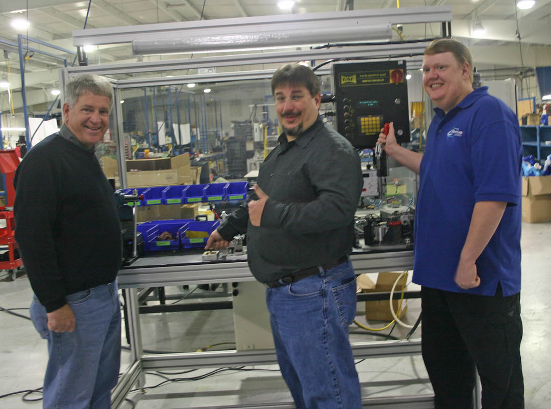 Click to enlarge,  Jerry Pedley (left), founder and president of Mertek Solutions, in Sanford, and two of his employees, Jeff Spivey, of Goldston, designer of mechanical assembly machines, and Craig Hart, of Gulf, designer of electrical assemble machines, check out one of the company's machines for assembling automotive parts. Pedley has a strong working relationship with Central Carolina Community College, where all his workers have received training, including Spivey and Hart. Since it opened in 2010, the company has grown to 33 employees and $4 million in annual sales. For more information about Mertek Solutions, visit  www.merteknc.com . For more information about Central Carolina Community College's engineering and industrial technologies programs and other programs, visit  www.cccc.edu . 