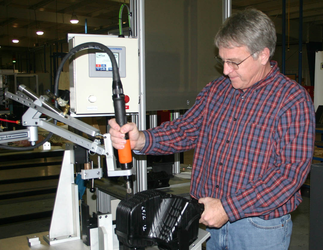 Click to enlarge,  Jerry Pedley, founder and president of Mertek Solutions, in Sanford, demonstrates one of the robotic assemblers at the company. Mertek is a globally oriented company whose engineers design and build automated testing and assembly equipment for a wide range of products in various industries. Since it opened in 2010, the company has grown to 33 employees and $4 million in annual sales. All of the company's technicians and engineers have received skill training through Central Carolina Community College's engineering and industrial technologies programs. The college's Industry Services Office also provides at-site workforce training. For more information about Mertek Solutions, visit  www.merteknc.com . For more information about Central Carolina Community College's engineering and industrial technologies programs and other programs, visit  www.cccc.edu . 