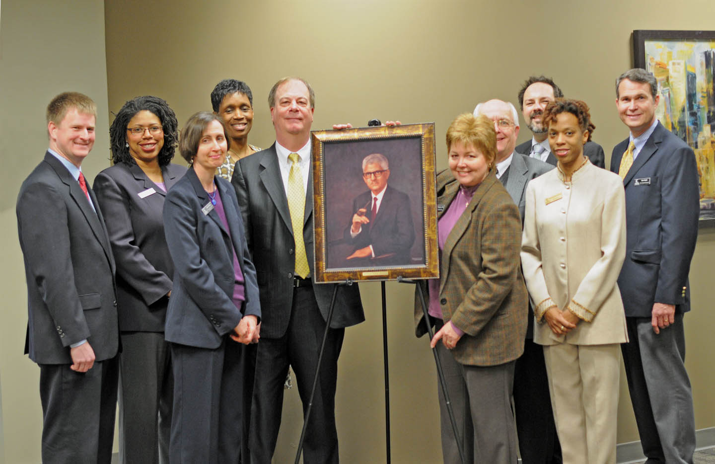 Click to enlarge,  Central Carolina Community College's President's Council gathered for the unveiling of a portrait of Dr. W. Dallas Herring at the college's Lee County Campus. The North Carolina Community College System and the 58 community colleges across the state recognized March 6 as "Dallas Herring Day." The portrait, a gift from the NCCCS, commemorates the  system's 50th anniversary and Herring's vision and tireless work in promoting community colleges as institutions of comprehensive education. Pictured (from left) are Dr. Phillip Price, vice president for Administrative Services; Dr. Pam Senegal, vice president for Economic and Community Development; Celia Hurley,  vice president for Instructional Advancement; Stacey Carter-Coley, Esq., executive director of Human Resources and Ethics Liaison; Dr. Bud Marchant, president; Dr. Lisa Chapman, executive vice president for Instruction; Bill Tyson, Harnett County provost; William Messersmith (back), associate director of Human Resources; Nicole Brown, Human Resources instructor; and Ken Hoyle, vice president of Student Services.  