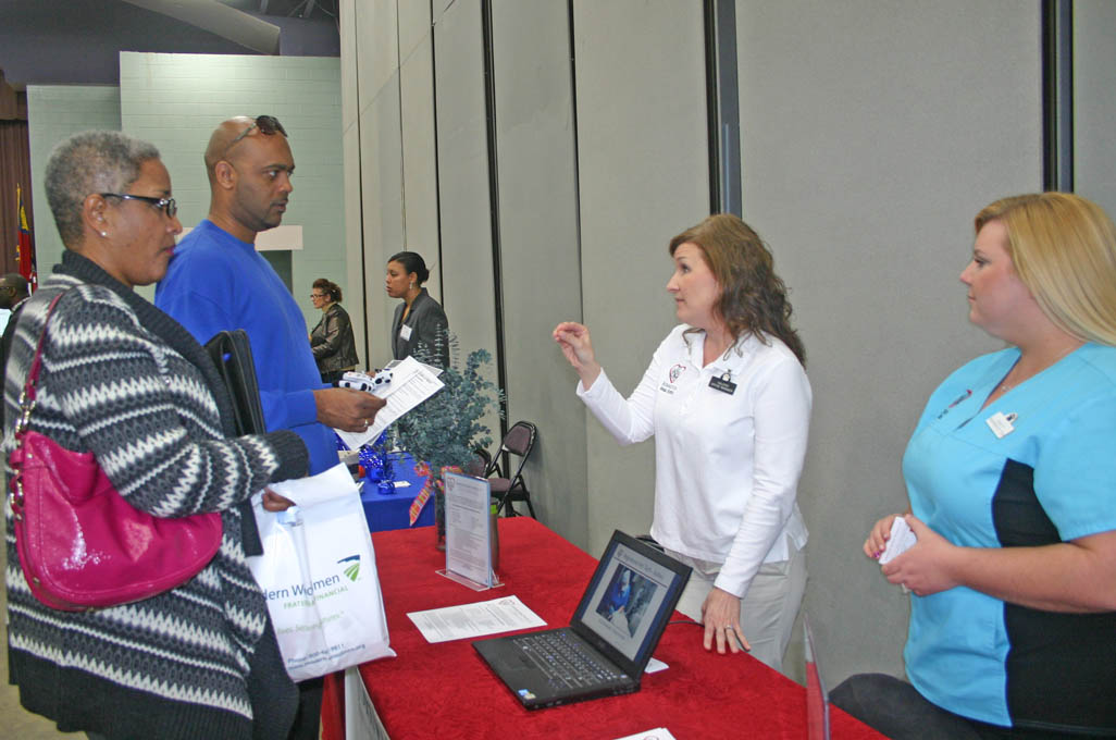 Click to enlarge,  Tonia Jones (left), of Angier, and David Saldy, of Erwin, Medical Office Administration students at Central Carolina Community College, visited the college's March 13 Career Fair at the Dennis A. Wicker Civic Center to speak with some of the approximately 70 employer vendors who participated. Johnston Animal Hospital office manager Valerie Price (center) and Registered Veterinary Technician Ashley Worley spoke with them about the variety of positions the hospital has. Worley is a 2010 graduate of CCCC. The Career Fair was sponsored by the college's Career Center. For more information about the services the Center offers, call 919-718-7396 or go to www.cccc.edu/careercenter/. 