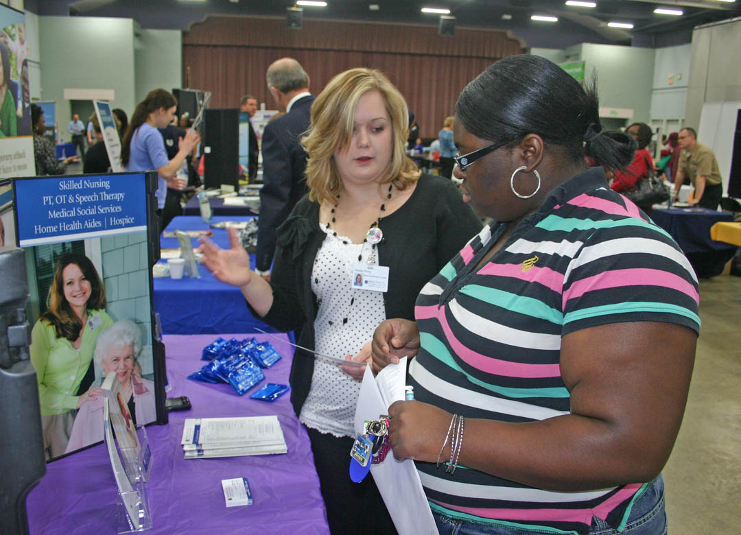 Click to enlarge,  Central Carolina Community College student Porsha Cooke (right), of Sanford, speaks with Liberty HomeCare and Hospice representative Emily Petty, of Siler City, about opportunities for employment with the company. Cooke will graduate in May with an Associate in Applied Science in Medical Office Administration. Petty graduated from CCCC in 2012, also with an A.A.S. in Medical Office Administration. The Career Fair was sponsored by the college's Career Center. For more information about the services the Center offers, call 919-718-7396 or go to www.cccc.edu/careercenter/. 