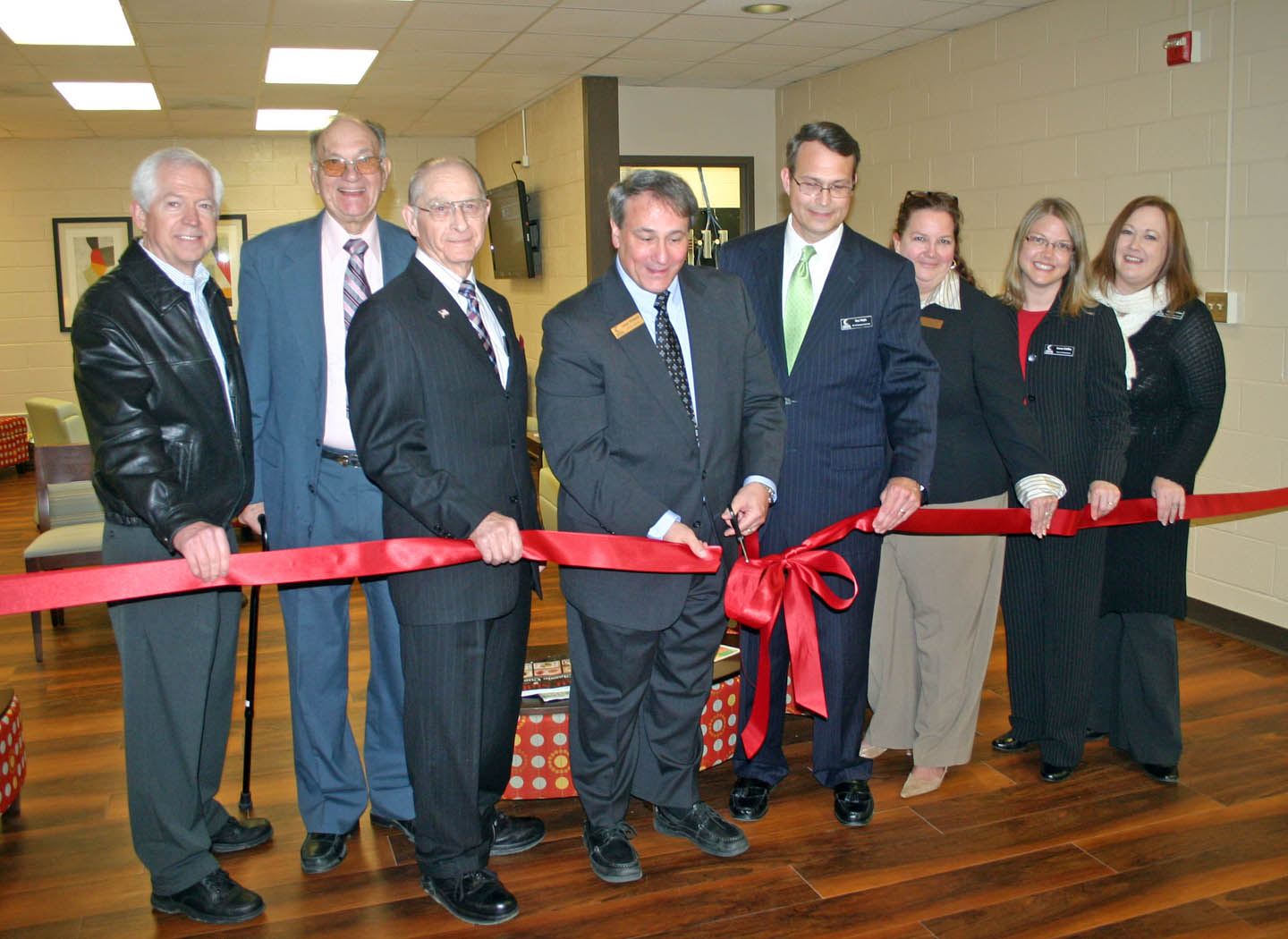 Click to enlarge,  Former and current directors of Central Carolina Community College and Student Services administrators joined CCCC Board of Trustees Chairman Julian Philpott (center, left) in the ribbon-cutting ceremony for the college's new Bell Welcome Center at its Lee County Campus. The Center serves as the college's 'front door,' where new students can receive counseling, assessments, and testing in one location. Joining in the ribbon-cutting were (from left) Dr. Matt Garrett, college president from 2004-2008, who started at the college as associate dean for Student Development in 1985; Hubert Garner, director of Student Services starting in 1965, then dean of Student Development Services from 1971-1991; Avron Upchurch, who started as an instructor in 1962 and retired in 1994 as executive vice president and chief academic officer; Philpott; Ken Hoyle, vice president of Student Services; Jamie Childress, dean of Enrollment Management/Registration; Jamee Stiffler, dean of Admissions ; and Heather Willett, dean of Student Support Services. The Center was created from Bell Hall, which was built in 1973 as the Adult Education Center, the second building on the Lee County Campus. It was renamed in 1975 for Dr. Edwin A. Bell, coordinator of evening programs from 1966 to 1973. He was the first person to have one of the college's buildings named after him. CCCC President Dr. Bud Marchant was out of town for a conference and unable to attend the ribbon cutting. For more information about services offered by the Student Services Division, go to www.cccc.edu/studentservices/. 