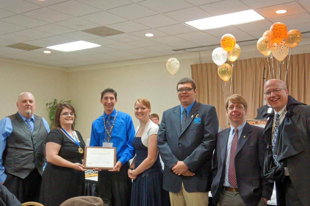 Click to enlarge,  Student officers and advisors of Central Carolina Community College's chapter of the Phi Theta Kappa International Honor Society (left) President Jonathan Stubbs, of Chatham County, and (starting third from left) Recording Secretary Zachary White, of Harnett County, Treasurer Kimberly Guin, of Lee County, Vice President Seth Tom, of Chatham County, and advisors Mark Hall and Mike Neal, display the Five Star Level Award plaque presented to them at the PTK's regional conference. Pictured with them is a Phi Theta Kappa Carolinas Region officer (second from left). Five Star is the highest level in the society's Chapter Development Plan, requiring the chapter members to meet high standards for chapter activity and college and community service. Phi Theta Kappa is the official honor society for two-year colleges and the largest honor society in American higher education. CCCC's chapter currently has 225 members. For more information about PTK's Beta Sigma Phi Chapter, visit www.cccc.edu and click on the A-Z index for Phi Theta Kappa, or contact Mark Hall, mhall@cccc.edu or 919-781-7422, or Mike Neal, mneal@cccc.edu or 919-718-7337. 