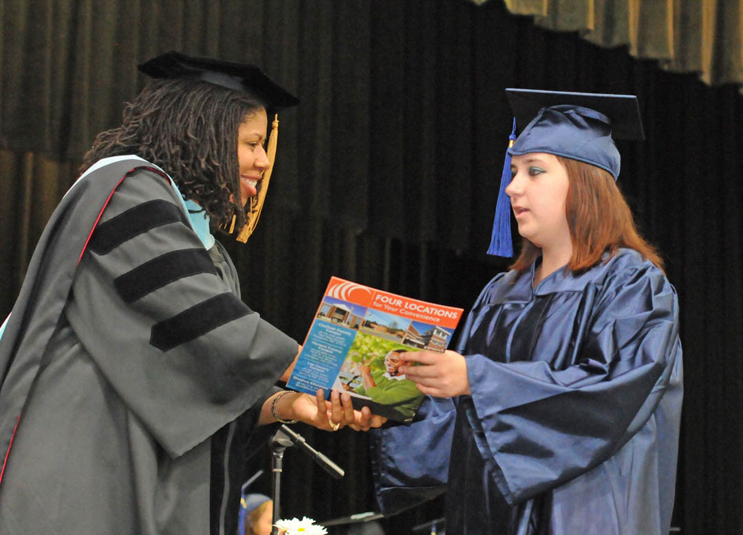 Click to enlarge,  Dr. Pam Senegal (left), Central Carolina Community College vice president for Economic and Community Development, congratulates Chatham County graduate Christie Beaman during the college's June 20 Adult High School and GED graduation program. More than 1,000 proud and excited family and friends filled the Dennis A. Wicker Civic Center main hall to celebrate the graduates' achievements. A total of 246 students earned Adult High School or GED diplomas through the college's College and Career Readiness division. For more information on the programs, visit www.cccc.edu or contact a College and Career Readiness office: Chatham County - 919-545-8661 or 919-545-8028, Harnett County - 910-814-8974, or Lee County - 919-777-7707. Para mas informacion en espanol - 919-545-8667. 