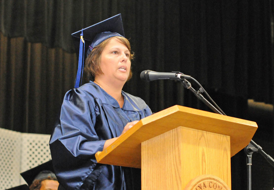 Click to enlarge,  Chatham County resident Tina Thomas addresses her fellow graduating class members during Central Carolina Community College's June 20 Adult High School and GED graduation exercises. More than 1,000 proud and excited family and friends filled the Dennis A. Wicker Civic Center main hall to celebrate the graduates' achievements. A total of 246 students earned Adult High School or GED diplomas through the college's College and Career Readiness division. For more information on the programs, visit www.cccc.edu or contact a College and Career Readiness office: Chatham County - 919-545-8661 or 919-545-8028, Harnett County - 910-814-8974, or Lee County - 919-777-7707. Para mas informacion en espanol - 919-545-8667.  