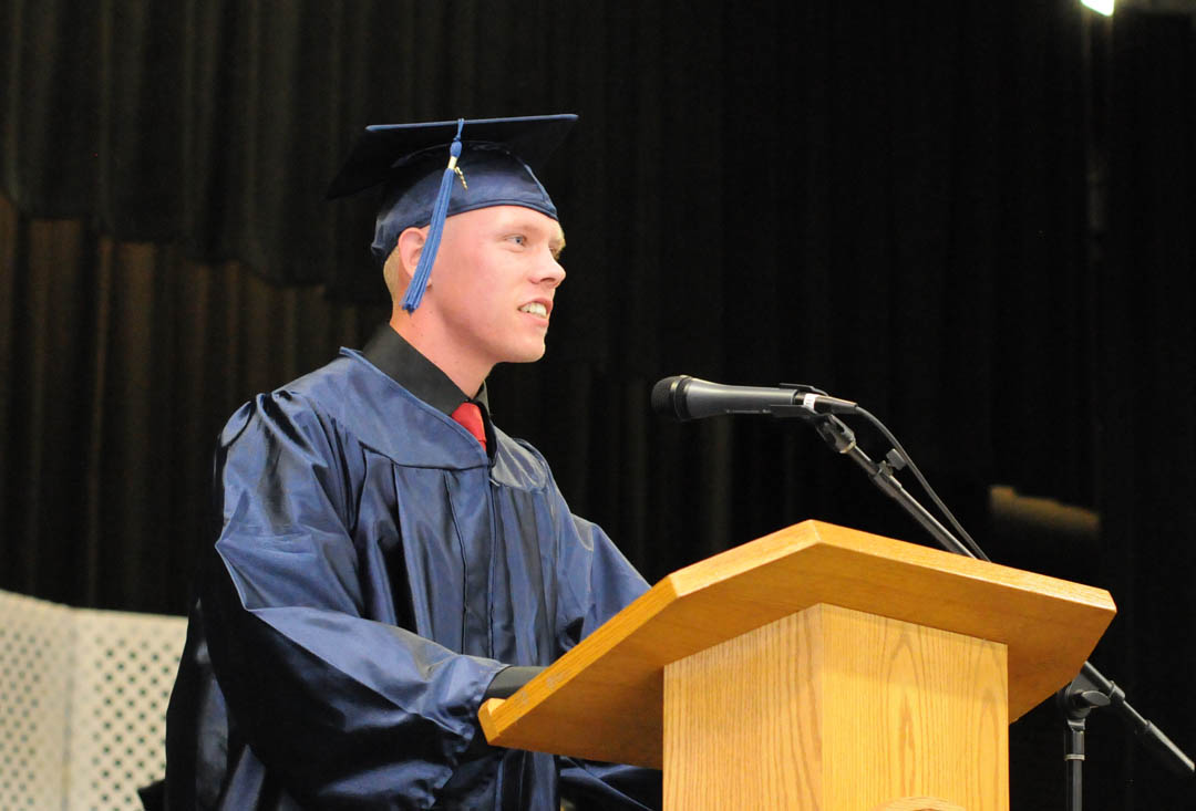 Click to enlarge,  Harnett County resident Joshua McCorquodale addresses his fellow graduating class members during Central Carolina Community College's June 20 Adult High School and GED graduation exercises. More than 1,000 proud and excited family and friends filled the Dennis A. Wicker Civic Center main hall to celebrate the graduates' achievements. A total of 246 students earned Adult High School or GED diplomas through the college's College and Career Readiness division. For more information on the programs, visit www.cccc.edu or contact a College and Career Readiness office: Chatham County - 919-545-8661 or 919-545-8028, Harnett County - 910-814-8974, or Lee County - 919-777-7707. Para mas informacion en espanol - 919-545-8667.  