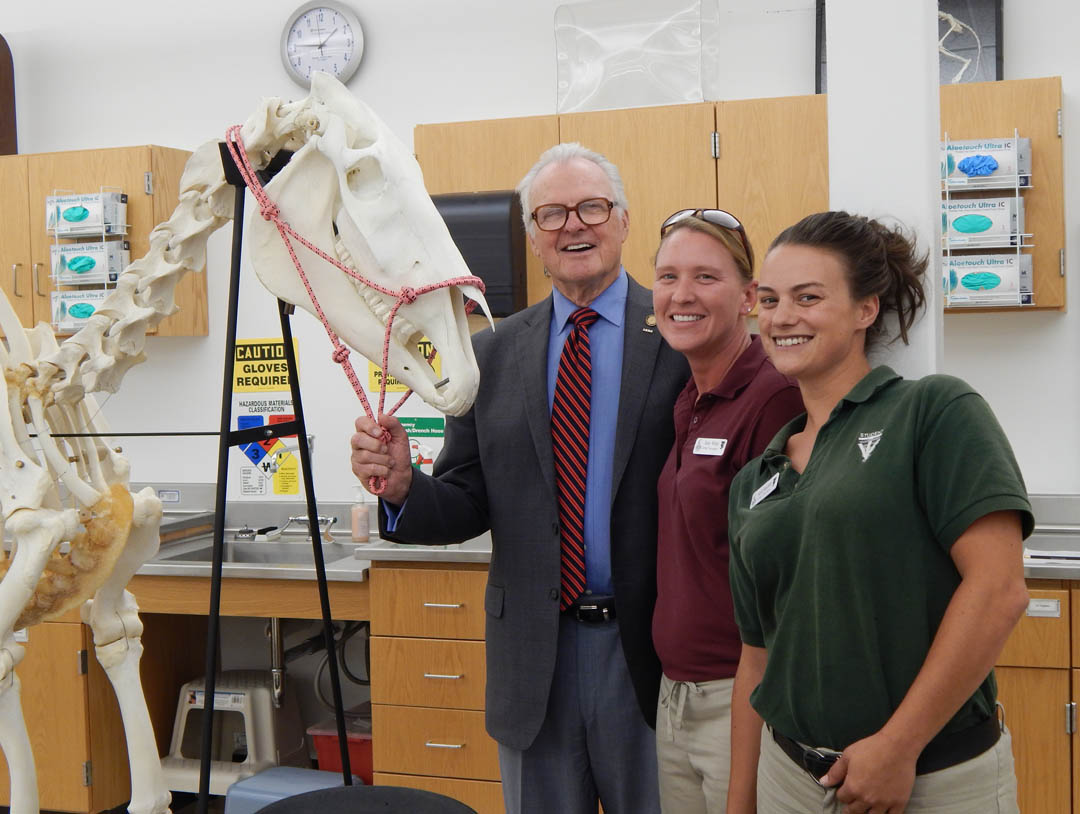 Click to enlarge,  North Carolina State Sen. Ronald Rabin (center), a retired U.S. Army colonel, visited Central Carolina Community College's Lee County Campus Sept. 17 to see some of the vocational programs that veterans are enrolled in and to speak to the Veterans Club. During his tour, he paused for a photo with the Veterinary Medical Technology horse skeleton and Army veterans Amy White, of Harnett County and Kelli Bechtler, of Randolph County, VMT students. The vocational training for in-demand careers and the support services the college offers veterans impressed him. For information about veterans' services at CCCC, call Tracey Gross, Veterans Affairs Coordinator, at 919-718-7233 or email at tgross@cccc.edu.  