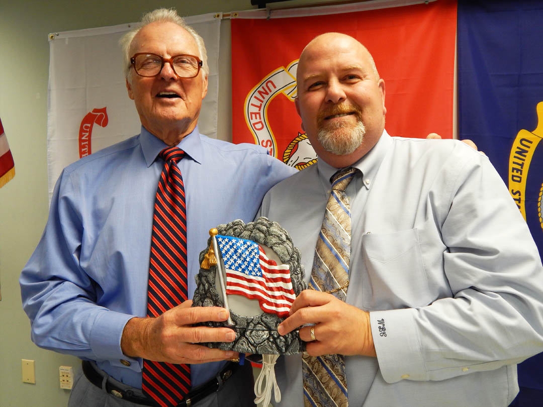 Click to enlarge,  Ben Cole (right) Central Carolina Community College lead engineering instructor and Veterans' Club advisor, presents a ceramic with an American flag to North Carolina State Sen. Ronald Rabin during Rabin's visit to the college's Lee County Campus Sept. 17. Rabin, a retired U.S. Army colonel, came to see some of the vocational programs that veterans are enrolled in and to speak to the Veterans Club. The vocational training for in-demand careers and the support services the college offers veterans impressed him. For information about veterans' services at CCCC, call Tracey Gross, Veterans Affairs Coordinator, at 919-718-7233 or email at tgross@cccc.edu.  