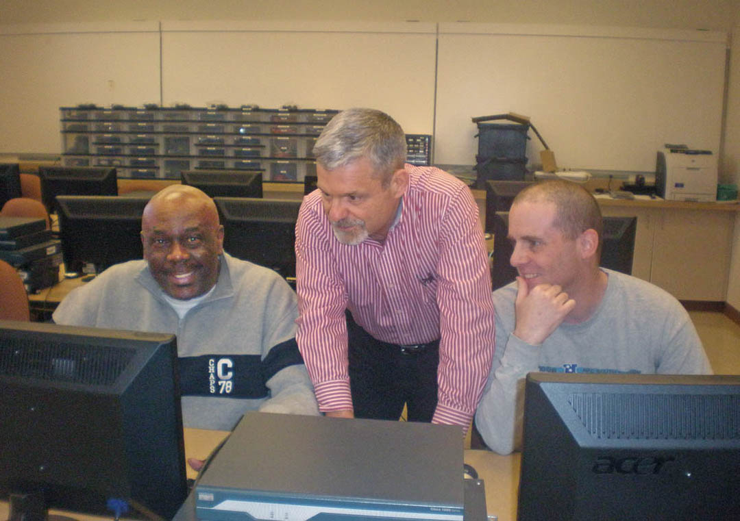 Click to enlarge,  Central Carolina Community College students (left) Lenwood House, of Fayetteville, and William F. Monahan (right), of Sanford, are learning highly marketable technical skills in telecommunications from Mike Murray (center), chair of the college's Networking and Telecommunications Department, and other instructors. The college offers Telecommunications Installation and Maintenance and Networking Technology programs at the North Carolina School of Telecommunications, 5910 Clyde Rhyne Drive, in the Lee County Industrial Park. For more information, contact Murray at 919-776-5812, ext. 7081, or by email at mmurray@cccc.edu. Information is also available at the college's website, www.cccc.edu. 