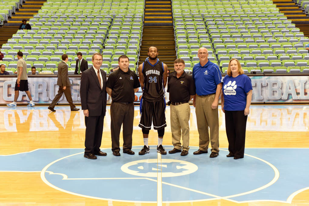 Click to enlarge,  Central Carolina Community College's Vice President of Student Services Ken Hoyle, Assistant Coach Brian Hurd, Player Marquise Richmond, Head Coach Doug Connor, Athletic Director Mike Neal, and Dean of Student Support Services Heather Willett were pictured at this year's game with the UNC JVs at the Dean Smith Center in Chapel Hill. 