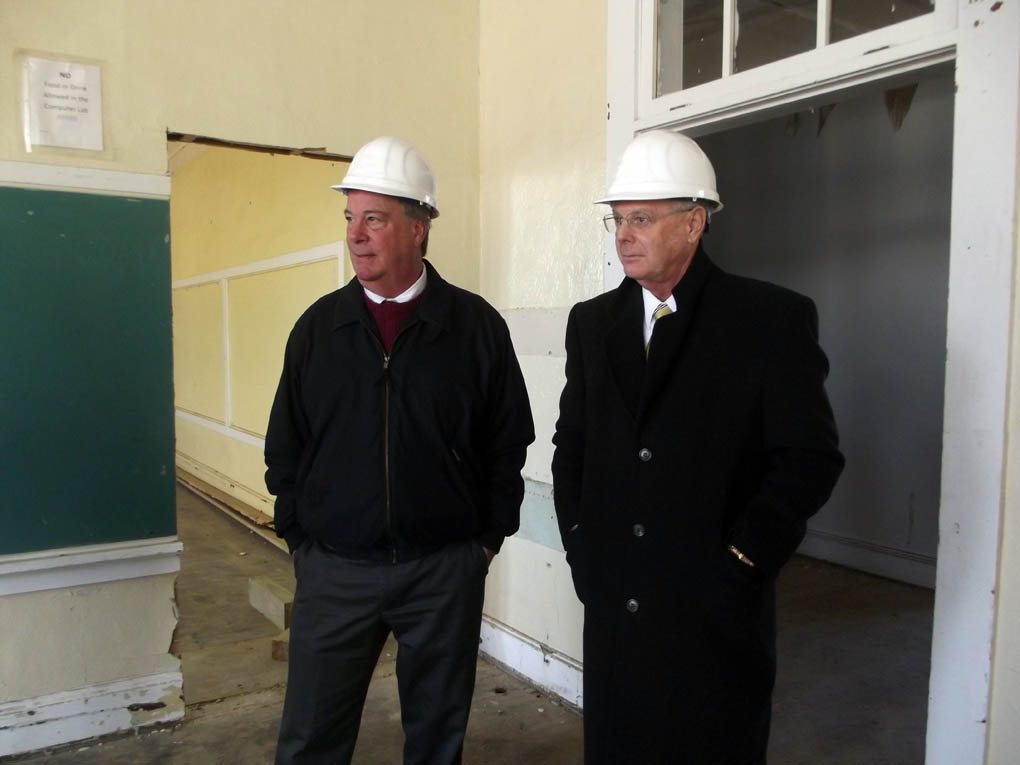Click to enlarge,  CCCC President Dr. Bud Marchant (left) and CCCC Trustee Clem Medley survey one of the areas in the Education Building that will house college classes at the former Harnett County Training School site in Dunn. 