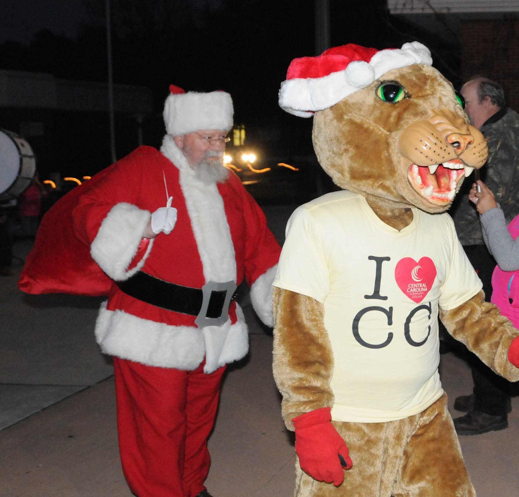 Click to enlarge,  Santa and Charlee Cougar, the Central Carolina Community College mascot, arrives at the CCCC Third Annual Christmas Tree Lighting celebration. 