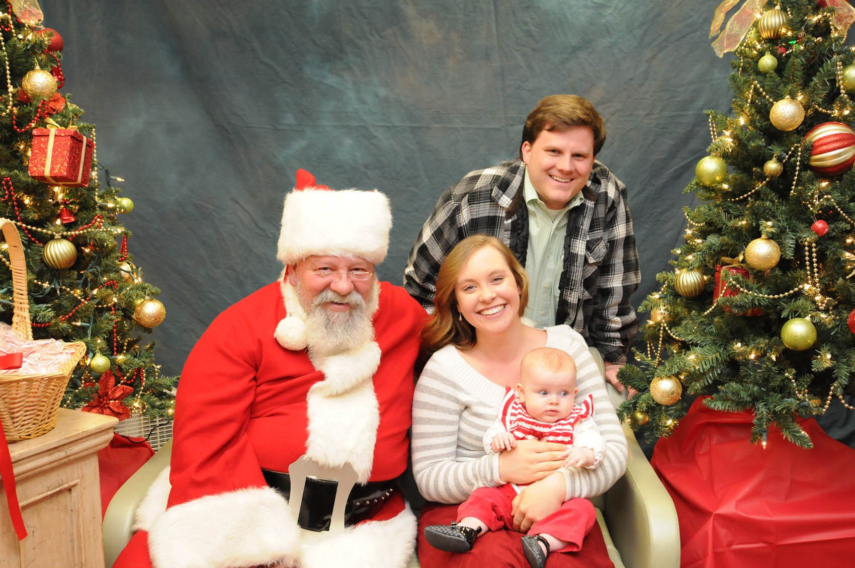 Click to enlarge,  Santa visits with 4-month-old Margaret Carr and her parents, Mitchell and Khala, at the CCCC Third Annual Christmas Tree Lighting celebration. 