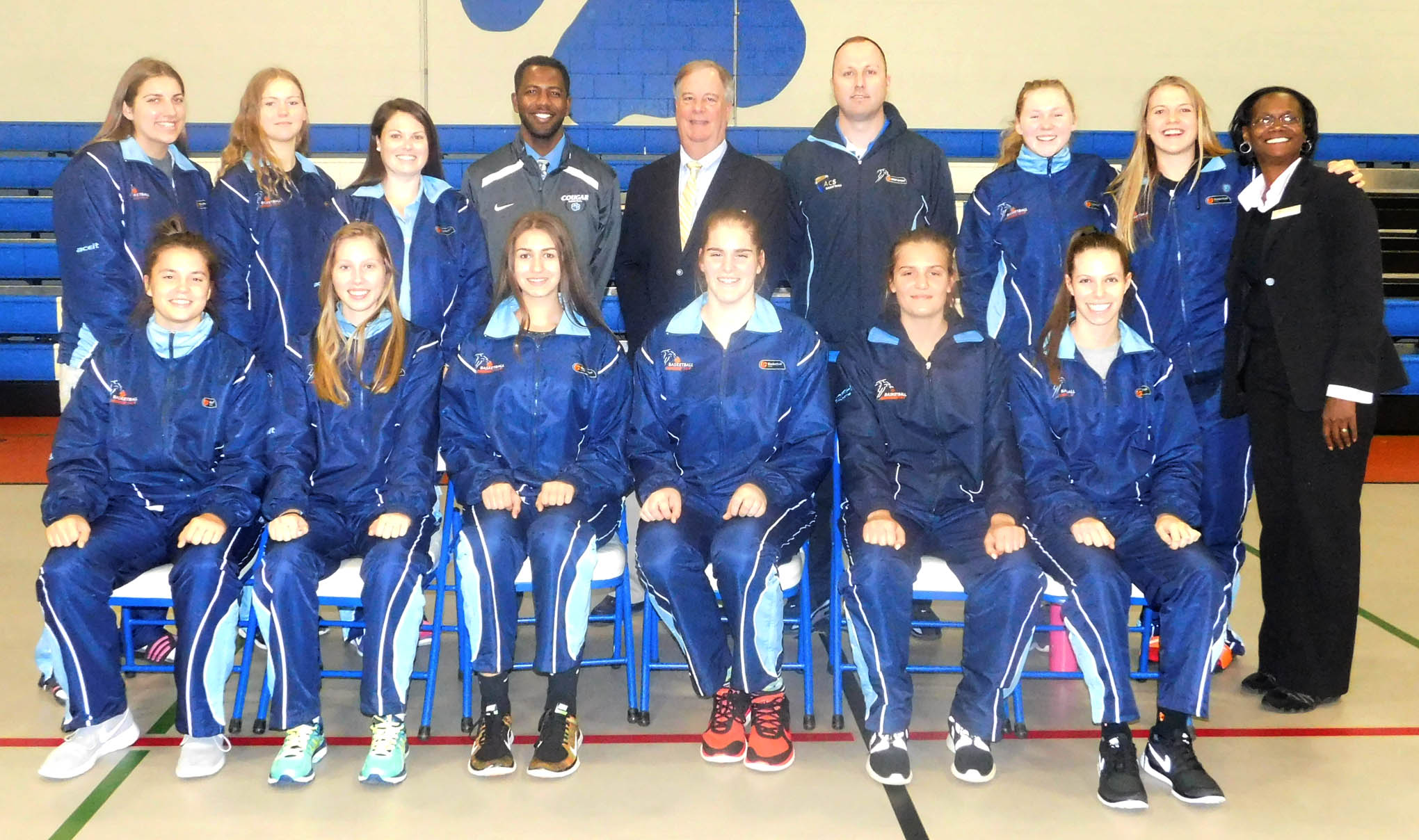 Click to enlarge,  Central Carolina Community College President Dr. T.E. Marchant (standing, fifth from left), CCCC Women's Basketball Coach Tierre Ramsey (standing, fourth from left), and CCCC Student Outreach &amp; Recruitment Specialist Wrenn Crowe (standing, far right) are pictured with the visiting basketball team from New South Wales, Australia. 