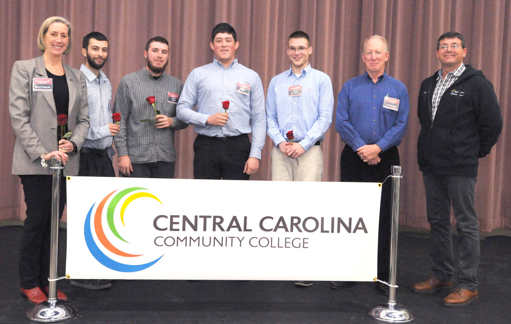 Click to enlarge,  Diane Fitzgerald (left), National Director of the Hagerty Education Program at LeMay - America's Car Museum (HEP-ACM), recently visited Central Carolina Community College. Pictured, left to right, are: Ms. Fitzgerald; CCCC Automotive Restoration students Daniel Palumbo, Russel French, Nathaniel Tucker, and William Crabtree; Bud McIntire, Hagerty Education Program NC Ambassador; and Craig Ciliberto, CCCC Transportation Technology Department Chair. 