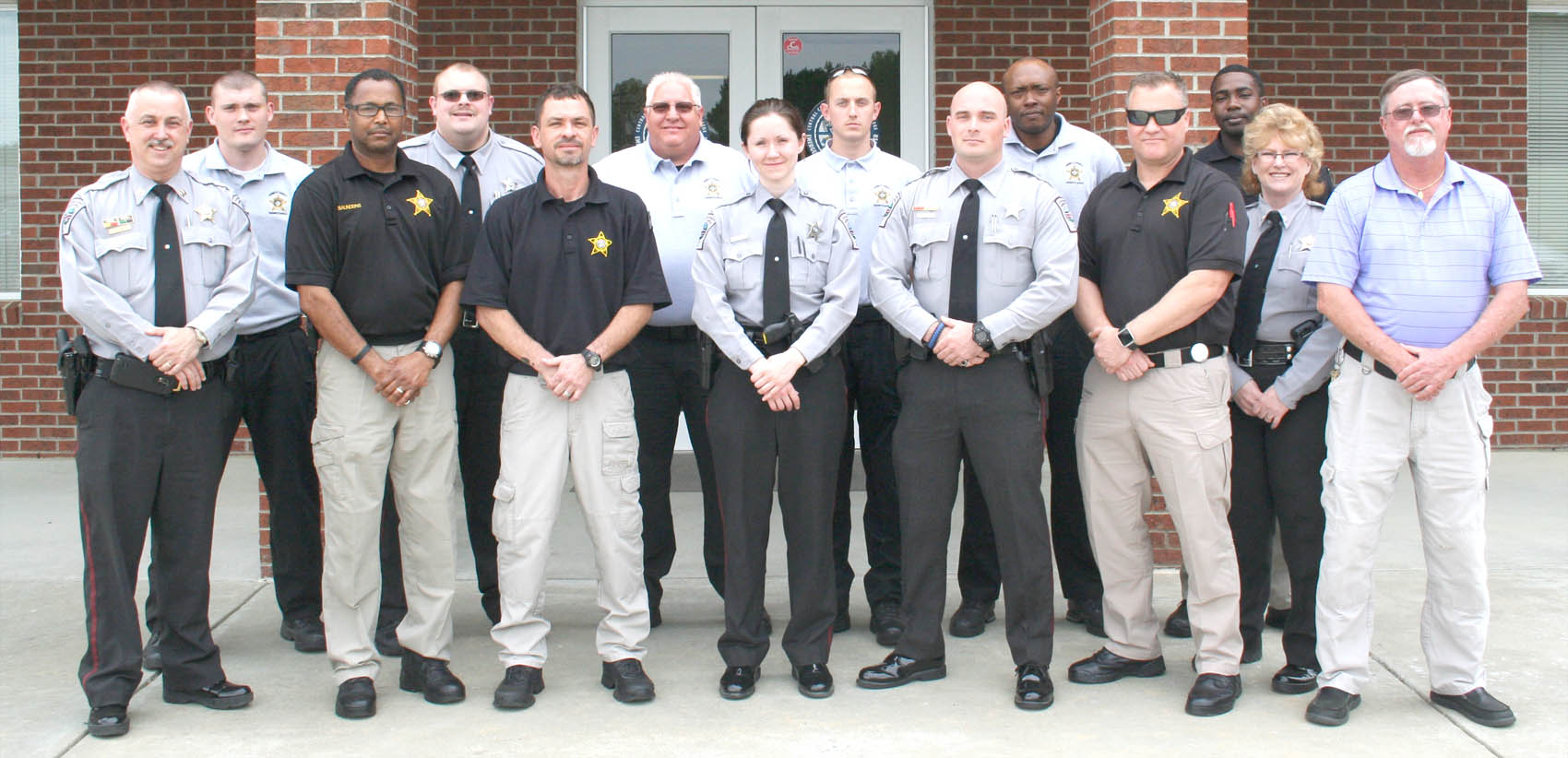 Click to enlarge,  Officers from the Chatham, Harnett, and Lee counties Sheriffs' offices graduated from Central Carolina Community College's Detention Officer School on Thursday March 31. Pictured are, left to right: front row, Capt. Douglas Stuart (School Director), Sorrell Saunders, Michael Bailey, Ashley Giles, Zach Blackwell, Gregory McCormick, Lt. Tammy Kirkman (Assistant), and Larry Foster (School Director); back row, Christopher Beasley, Chad Collins, Tracy Hamby, Marcus Allen, Amritraj Lock, and Brandon Covington. 