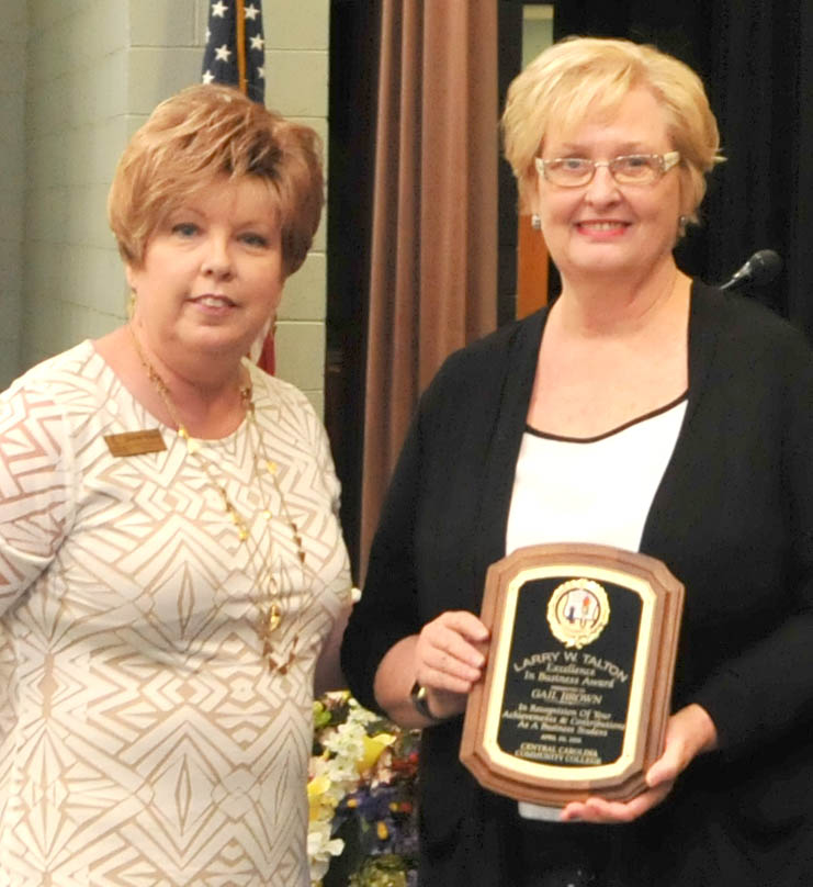 Click to enlarge,  Gail Brown (right) is recipient of Central Carolina Community College's Larry Talton Excellence in Business Award. Presenting the award to Brown is Shirley Rijkse, CCCC Human Resource Management Instructor. 
