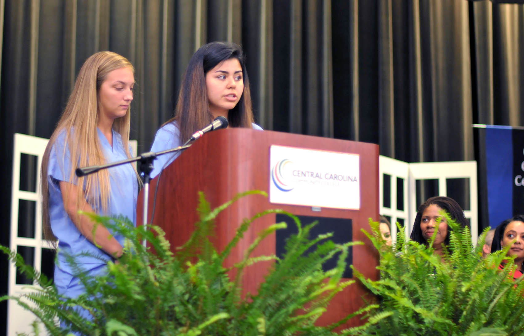 Click to enlarge,  Brooke Madison and Zuheryi Lievano, of Harnett County, were among the student speakers at the Central Carolina Community College Continuing Education medical programs graduation. The event was held May 26 at the Dennis A. Wicker Civic Center in Sanford. For more information about Continuing Education medical programs, call Lennie Stephenson, CCCC's Director of Continuing Education medical programs, at 910-814-8833 or email lstephenson@cccc.edu. 