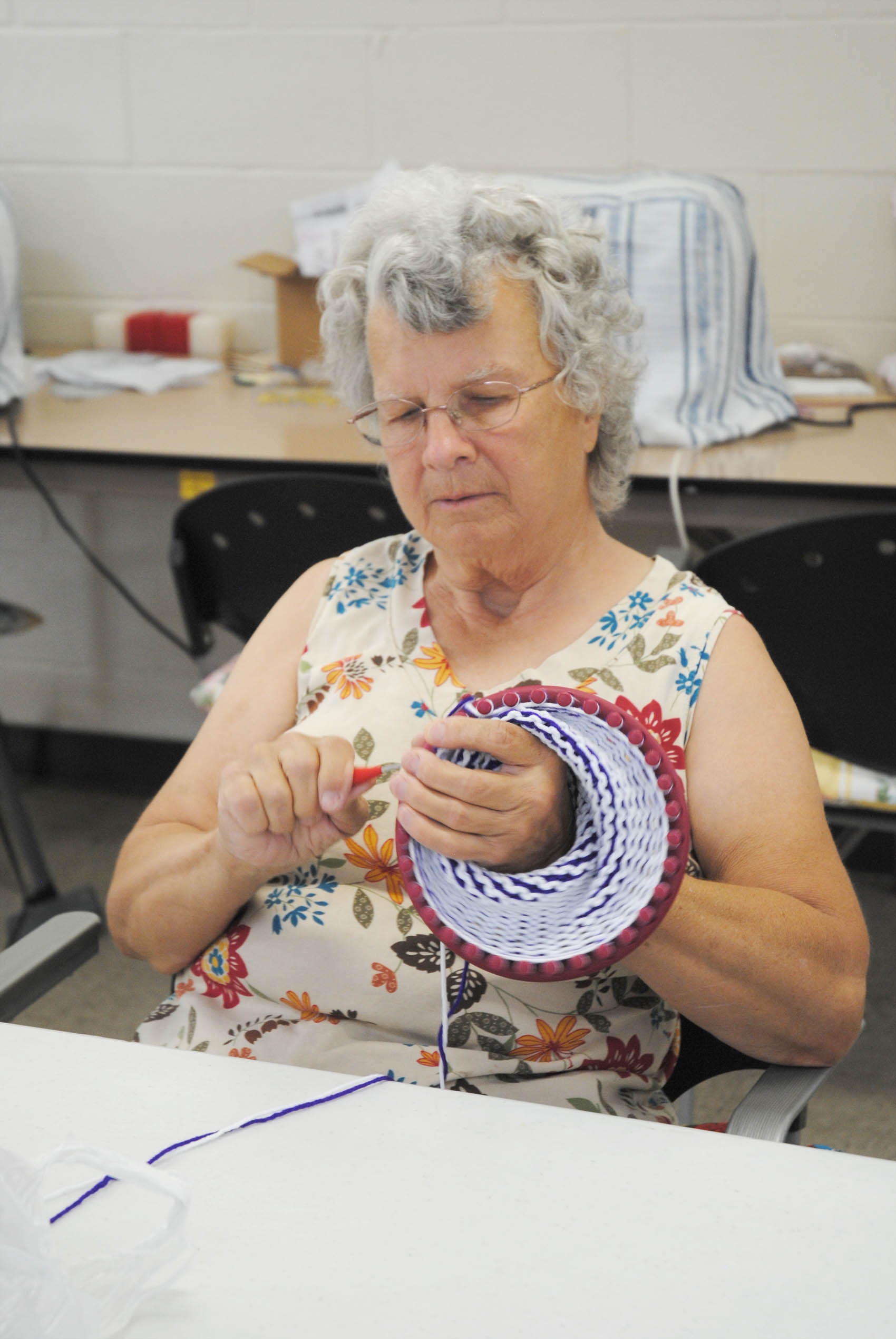 Click to enlarge,  Maxine Dennis knits one of the last caps that will be created before the Dunn Senior Enrichment Center's move from the Powell Avenue location to the newly-remodeled Harnett Training School campus. 