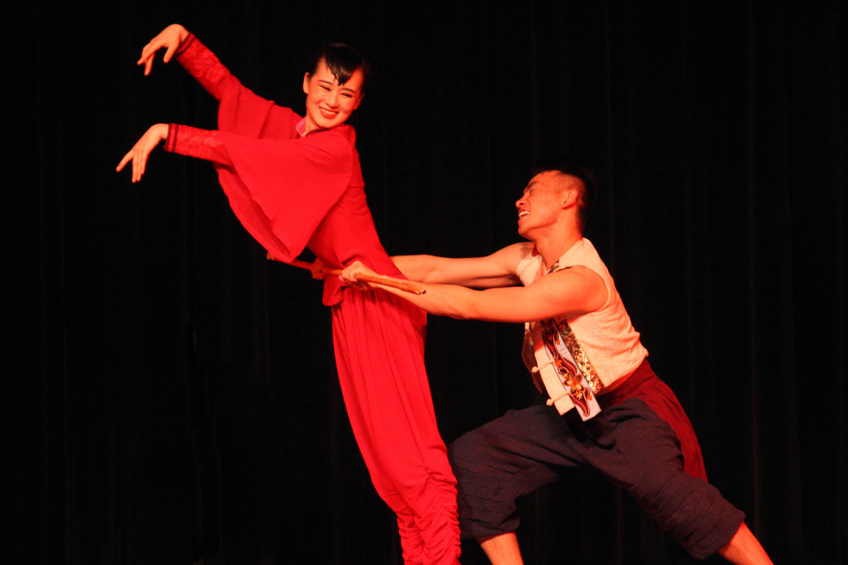 Click to enlarge,  Hu Xuedong, left, and Yang Yijie perform a dance duet, "Red Sorghum," as part of a lively afternoon of dance and music presented by artists from Shanxi University in China. 