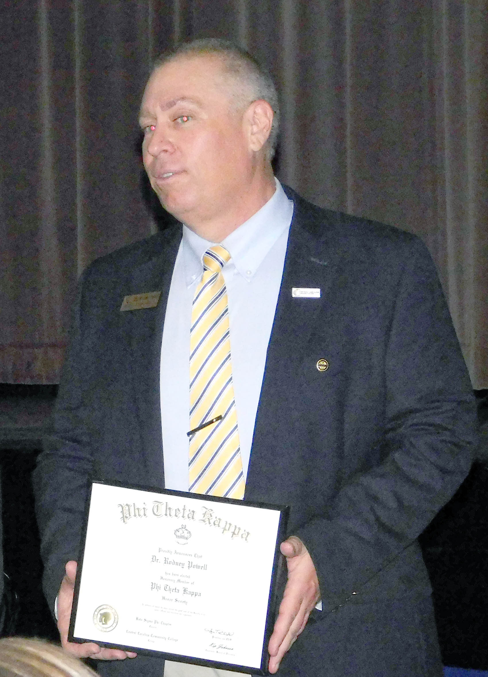 Click to enlarge,  Dr. Rodney Powell, Central Carolina Community College Phi Theta Kappa Chapter Advisor and Chemistry Instructor, was saluted with a PTK honorary membership during the spring induction ceremony. 