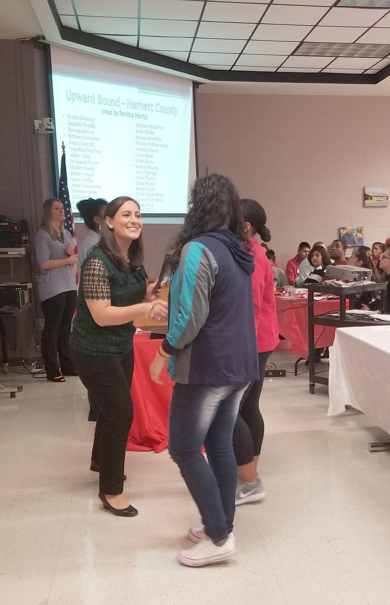 Click to enlarge,  Rebeccah Lystash, Upward Bound TRiO Director at Central Carolina Community College, welcomes a Lee County student to the Upward Bound program. 

