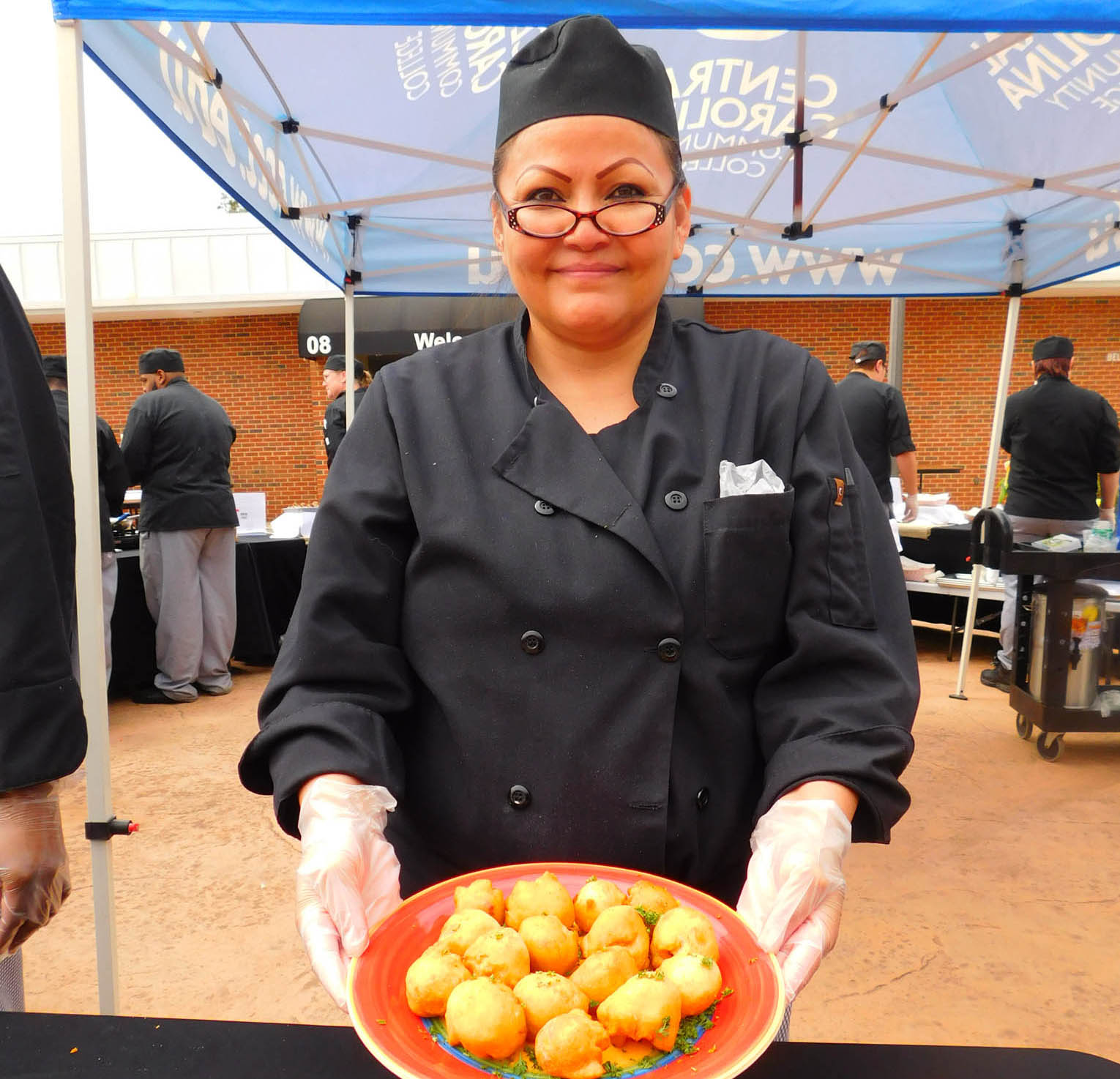 Click to enlarge,  Doni Shepard Steele, of Siler City, with her Bacon Pimento Cheese Bombs, won the People's Choice Award at the Central Carolina Community College 3rd Annual Culinary Showcase. The event, featuring dishes by Culinary &amp; Hospitality Arts students represented from Chatham, Harnett, and Lee counties, was held April 11th on the Central Carolina Community College Lee Main Campus in Sanford. For more information on the CCCC Culinary &amp; Hospitality Arts program, visit www.cccc.edu/culinaryarts/. 