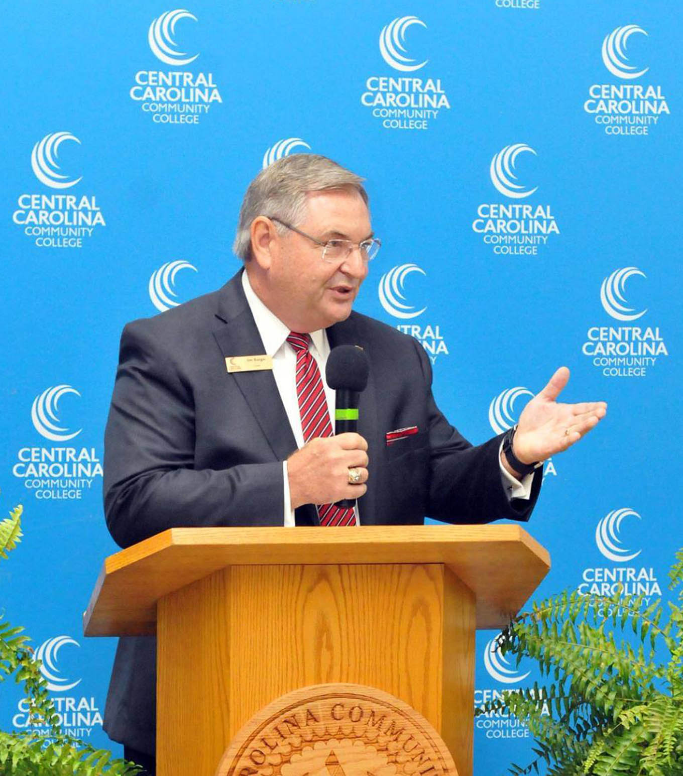 Click to enlarge,  Jim Burgin, Vice Chair of the Central Carolina Community College Board of Trustees, spoke to attendees at the ribbon-cutting event to celebrate the opening of the West Harnett Center Automotive Restoration Facility. 