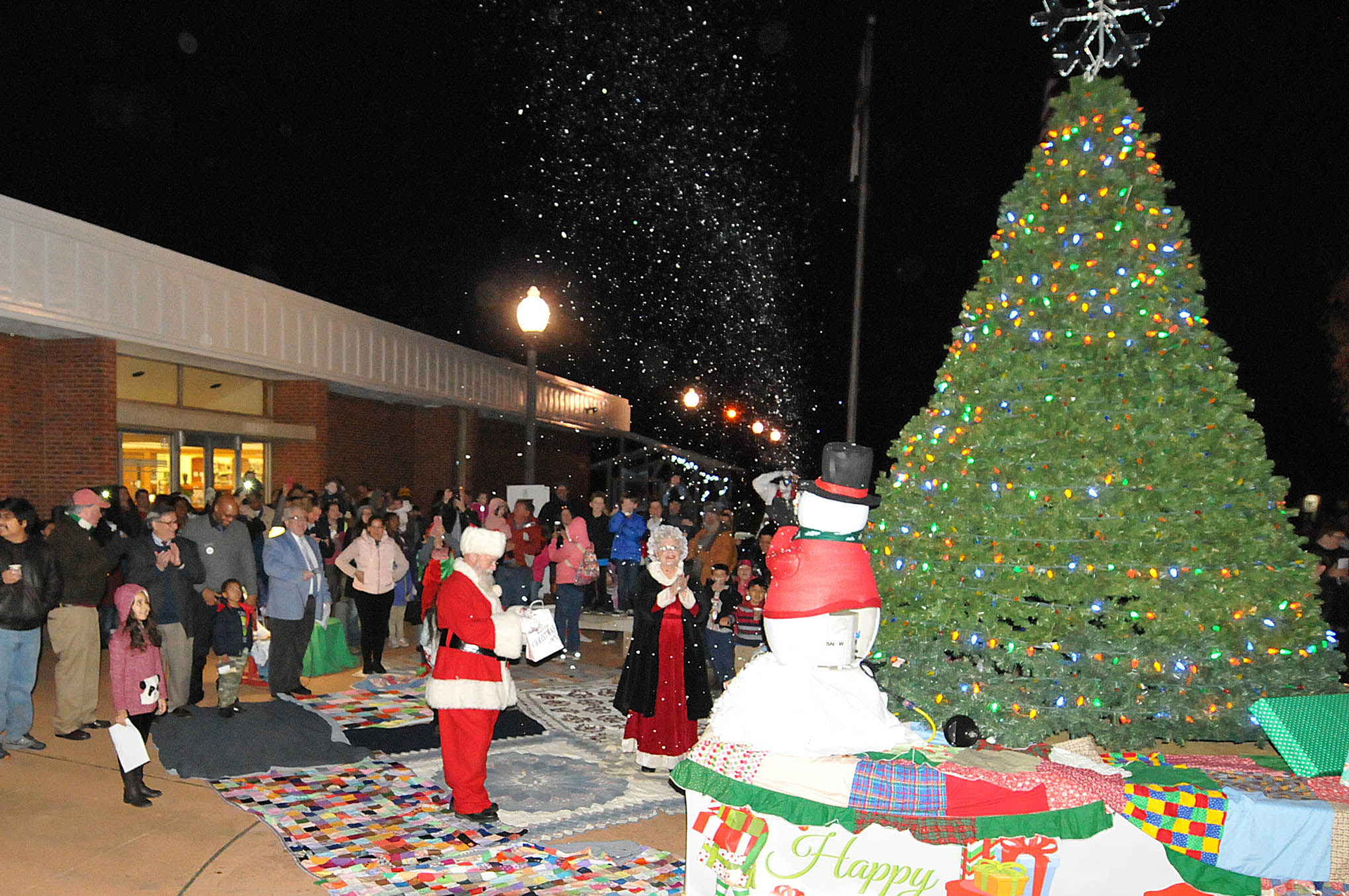 Click to enlarge,  Children and their families counted down to the moment when the Christmas tree suddenly glowed with its bright lights at the CCCC Foundation Christmas Tree Lighting celebration. 