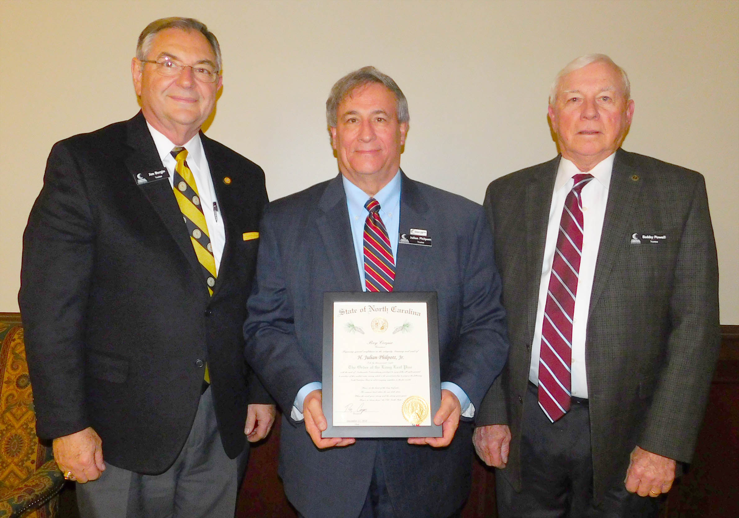 Click to enlarge,  H. Julian Philpott Jr. (center), Chairman of the Central Carolina Community College Board of Trustees, recently received The Order of the Long Leaf Pine, a prestigious award given by the Governor of North Carolina. Philpott is a corporate attorney who has spent the last 30 years working as a lobbyist and general counsel for the nonprofit North Carolina Farm Bureau Federation and its affiliated companies. He is now a Senior Partner with Hayes Group Consulting. Pictured with Philpott are two other members of the CCCC Board of Trustees who also have received The Order of the Long Leaf Pine -- State Sen. Jim Burgin (left) and L.W. "Bobby" Powell (right). 