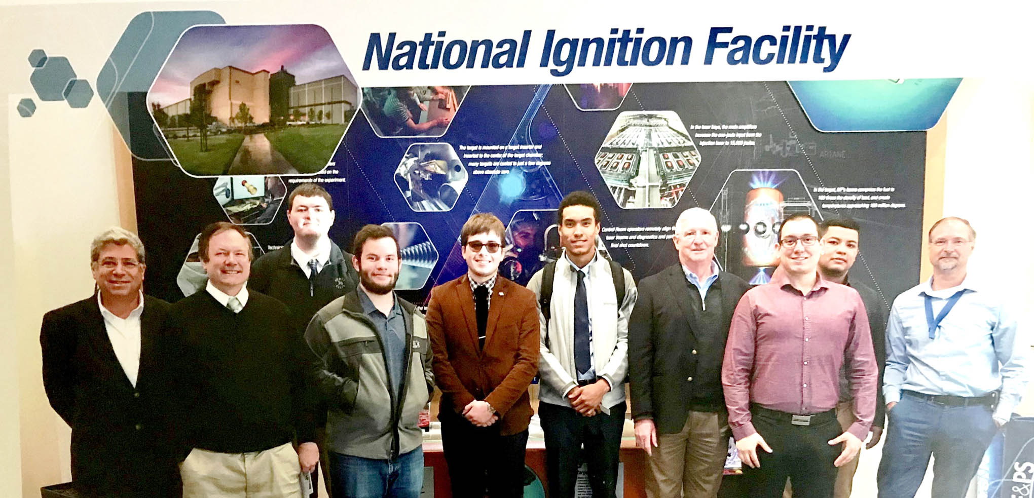 Click to enlarge,  Second-year students in the Laser and Photonics Technology program at Central Carolina Community College's Harnett Main Campus toured the LLNL NIF Facility in California. Pictured are, left to right: Chrysanthos Panayiotou (LASER-TEC Principal Investigator), Robert Strickland, Ian Washburn, Cameron Wiedholz, Jamie Turner, Brandon Pasley, Gary Beasley (lead instructor), Al Delong (2015 CCCC Laser Graduate with LLNL, who help lead the tour), Kilvet Zalavarria, and Brian Olejniczak (LLNL Laser Systems Engineering &amp; Operations Director). 