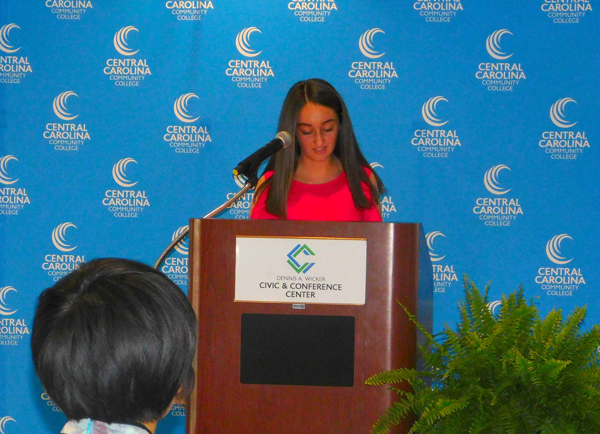 Click to enlarge,  Central Carolina Community College hosted a Ninth Anniversary and farewell honoring Yuehan Ma and the CCCC Confucius Classroom. Here, student Audrey Thomas speaks to the audience. 