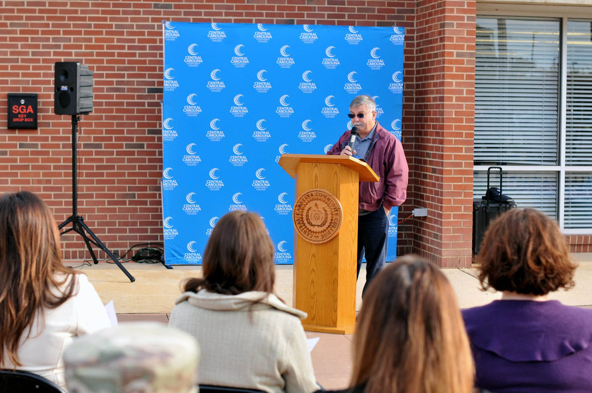 Click to enlarge,  Richard Biggs, Central Carolina Community College Instructor and U.S. Air Force Retired, speaks during a Veterans Day Ceremony held Monday, Nov. 11, at the CCCC Lee Main Campus in Sanford, N.C. 