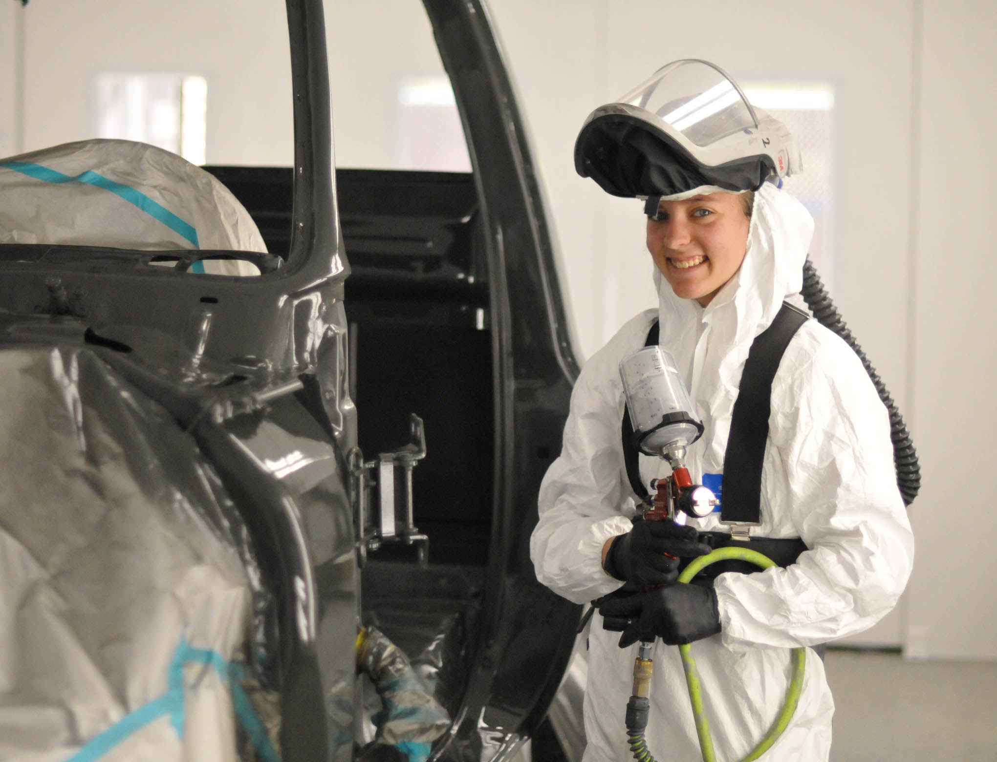 Click to enlarge,  Kassidy Nixon of Lillington, a student in the Central Carolina Community College Automotive Restoration Program, works on a vehicle. 