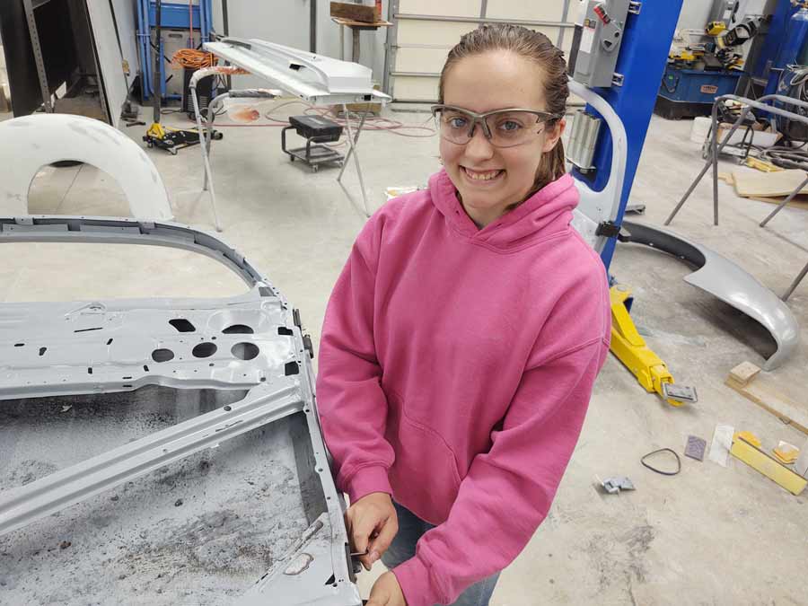 Click to enlarge,  Kassidy Nixon works on door hardware on this 1940 Ford, which is being restored by the Central Carolina Community College Automotive Restoration Technology program thanks to funding from the RPM Foundation. 