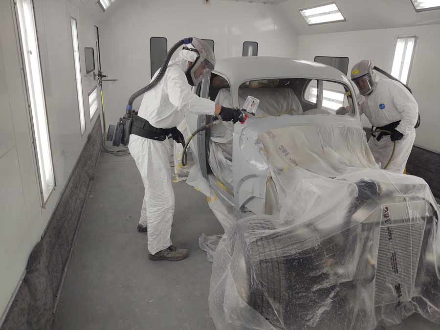 Click to enlarge,  Justin Arace and Jeff Chandler spraying primer on this 1940 Ford, which is being restored by the Central Carolina Community College Automotive Restoration Technology program thanks to funding from the RPM Foundation. 