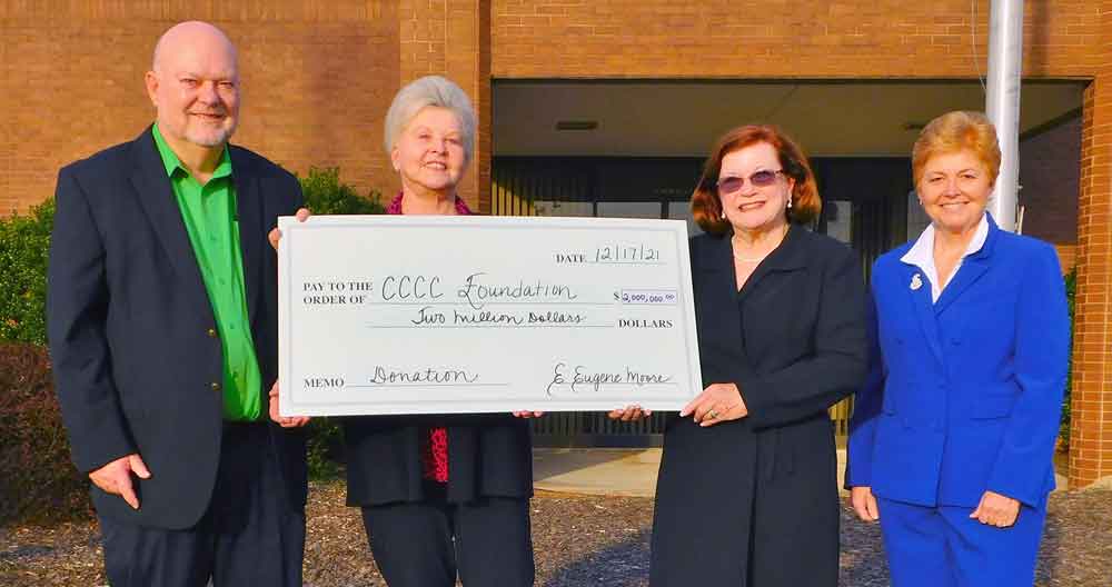 Click to enlarge,  Central Carolina Community College alumnus E. Eugene Moore (left) is being recognized for his $2 million gift to his alma mater with the naming of the future E. Eugene Moore Manufacturing and Biotech Solutions Center in his honor. Pictured with Moore are, left to right: his wife, Ruby; CCCC Foundation Board Chair Lynda Turbeville; and CCCC President Dr. Lisa M. Chapman. 