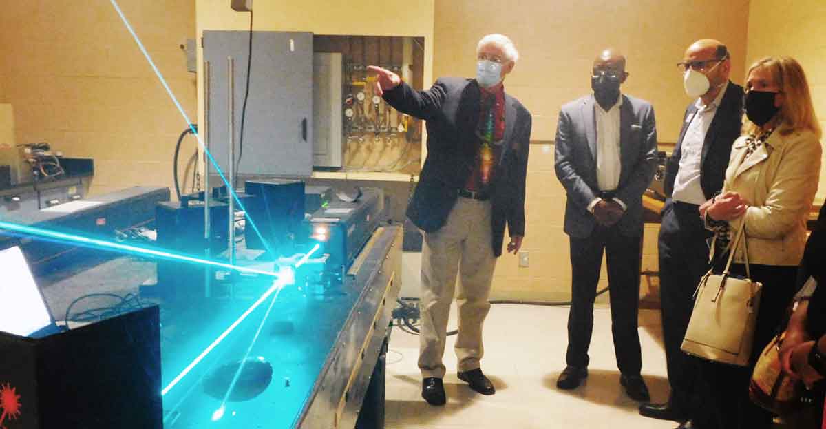 Click to enlarge,  Gary Beasley (left), Central Carolina Community College Laser and Photonics Lead Instructor, shows off a laser to Blue Cross Blue Shield of North Carolina executives at the Central Carolina Community College Harnett Main Campus in Lillington on Friday, Feb. 4. 