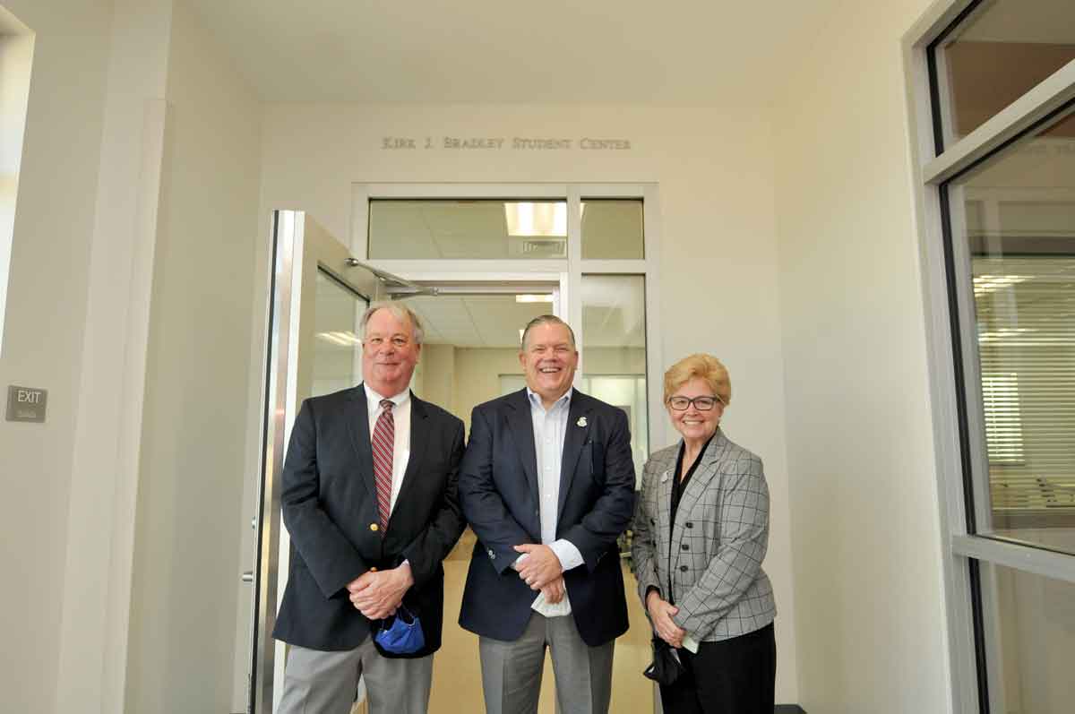 Click to enlarge,  In honor of the strong support and commitment Kirk J. Bradley (center) has provided to Central Carolina Community College, the college's student center at CCCC's Chatham Health Sciences Center (CHSC) is now recognized as the Kirk J. Bradley Student Center. A celebration of this recognition took place on Friday, Feb. 18, at the CCCC CHSC facility located in Chatham County. Among those joining in the celebration were former CCCC President Dr. T. Eston "Bud" Marchant (left) and current CCCC President Dr. Lisa M. Chapman (right). 