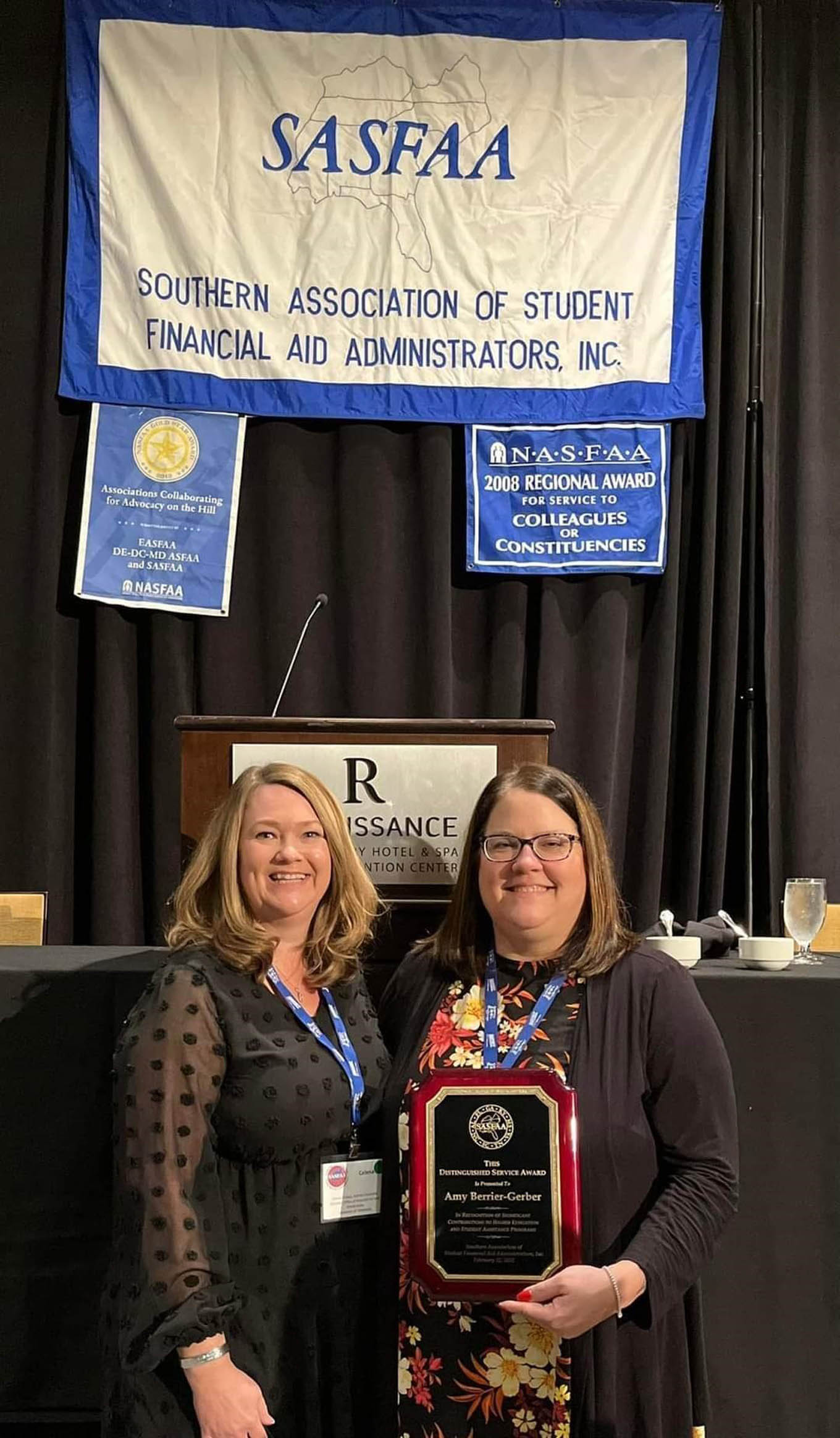 Click to enlarge,  Amy Berrier-Gerber (right), Central Carolina Community College Associate Director of Financial Aid, received the Southern Association of Student Financial Aid Administrators (SASFAA) Distinguished Service Award at the organization's annual conference in Montgomery, Ala. Presenting the award was current SASFAA President Celena Tulloss of the University of Tennessee. 