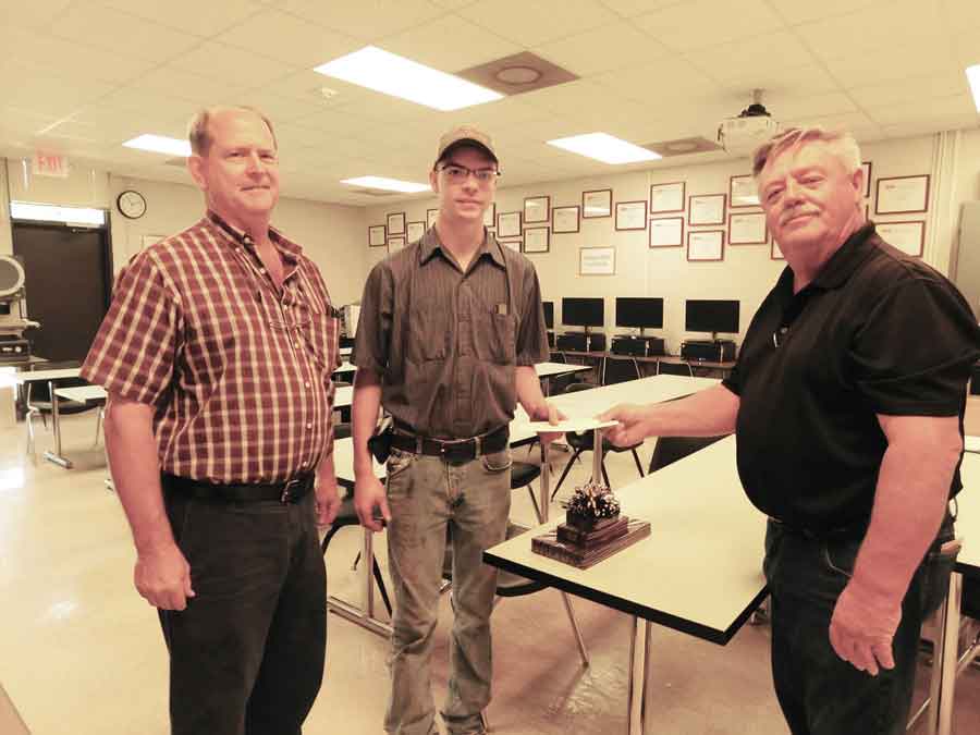 Click to enlarge,  Graham Stafford (center) of Siler City, a student in the Central Carolina Community College Computer-Integrated Machining Program, has received a recognition award given in memory of Gilbert A. Toon. The gift - a Starrett 4-piece combination set-- was given through the CCCC Foundation by Mr. Toon's wife, Phyllis A. Toon of Pittsboro. Stafford is pictured along with Glenn Shearin (left), CCCC Computer-Integrated Machining Instructor, and Edwin Thomas (right), CCCC Computer-Integrated Machining Chair. 