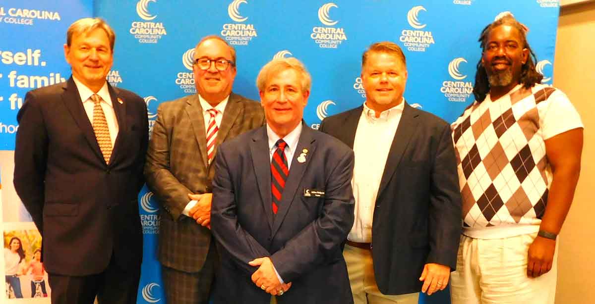 Click to enlarge,  Central Carolina Community College's new and reappointed Trustees were pictured at the CCCC Board of Trustees' meeting on Thursday, Sept. 1. Susie K. Thomas, Clerk of Superior Court in Lee County, conducted the ceremony. Pictured are, left to right: Trustees Jim Womack, Chip Post, Julian Philpott, Jamie Kelly, and Regonal Spinks (who serves as CCCC Student Government Association President).</p