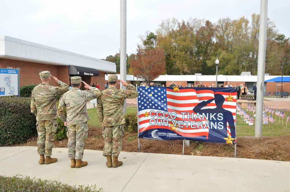 Click to enlarge,  Members of the Campbell University ROTC salute the American flag during the Central Carolina Community College Veterans Day Ceremony on Thursday, Nov. 10. 

