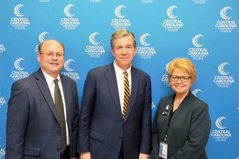 Click to enlarge,  N.C. Governor Roy Cooper (center) visits with Dr. Andy Bryan (left), Lee County Schools Superintendent, and Dr. Lisa Chapman (right), CCCC President. 
