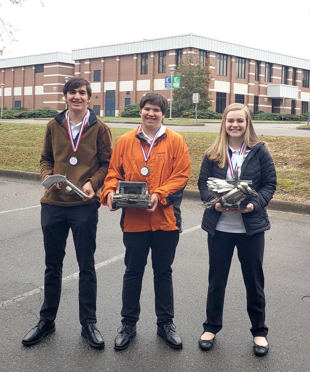 Click to enlarge,  Three students - all participants in the Central Carolina Community College Career &amp; College Promise program -- won honors in the Welding Sculpture Competition of the NC SkillsUSA High School Job Skills regional event. Pictured are, left to right: Joseph King (fourth place), Crozes Crean (second place), and Sarah Barbour (first place). 