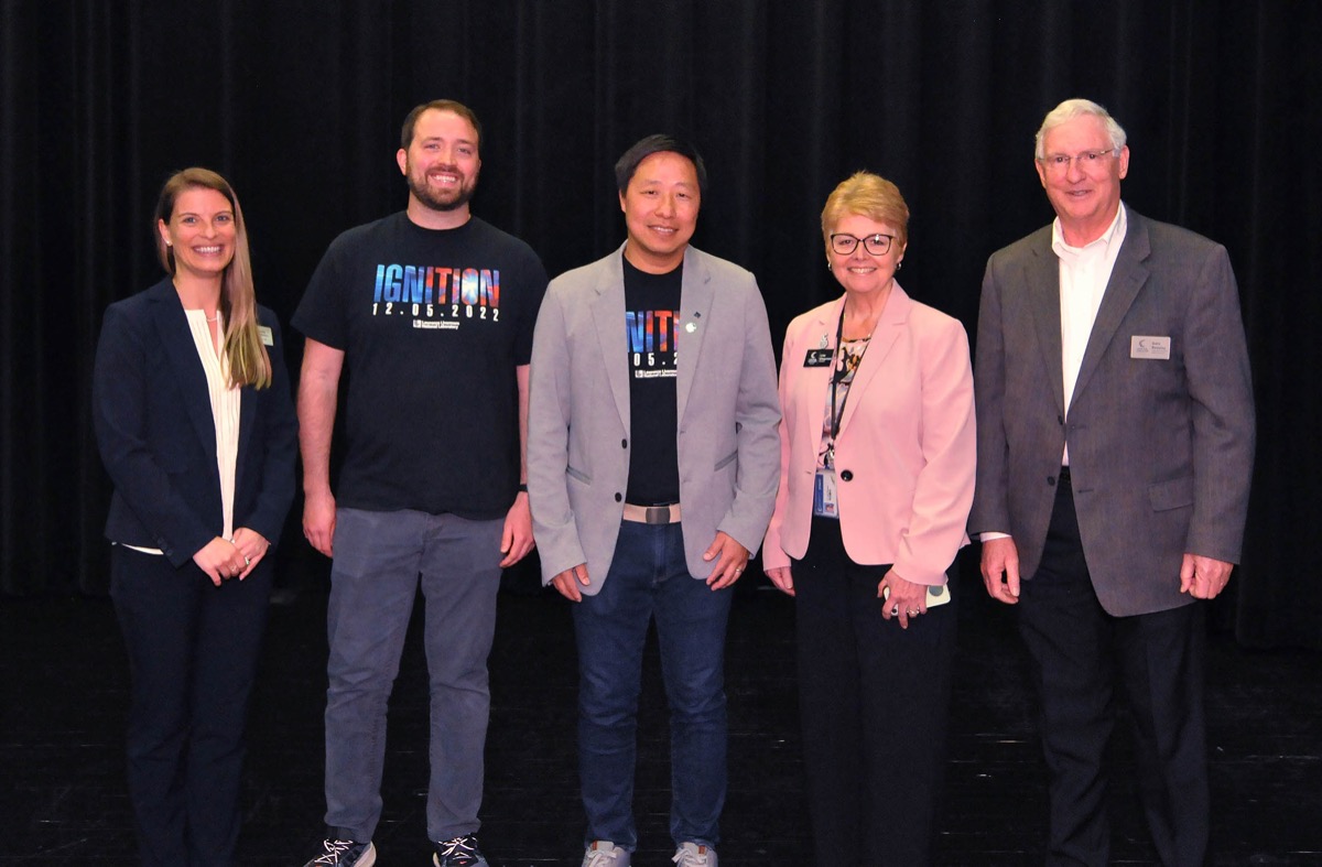 Click to enlarge,  David Pope (second from left) and Dr. Zhi M. Liao (center), both of Lawrence Livermore National Laboratory, visited Central Carolina Community College on April 25. They are pictured with Dr. Cristy Holmes (far left), CCCC Dean of Arts and STEM; Dr. Lisa M. Chapman (second from right), CCCC President; and Gary Beasley (far right), CCCC Laser &amp; Photonics Lead Instructor. 