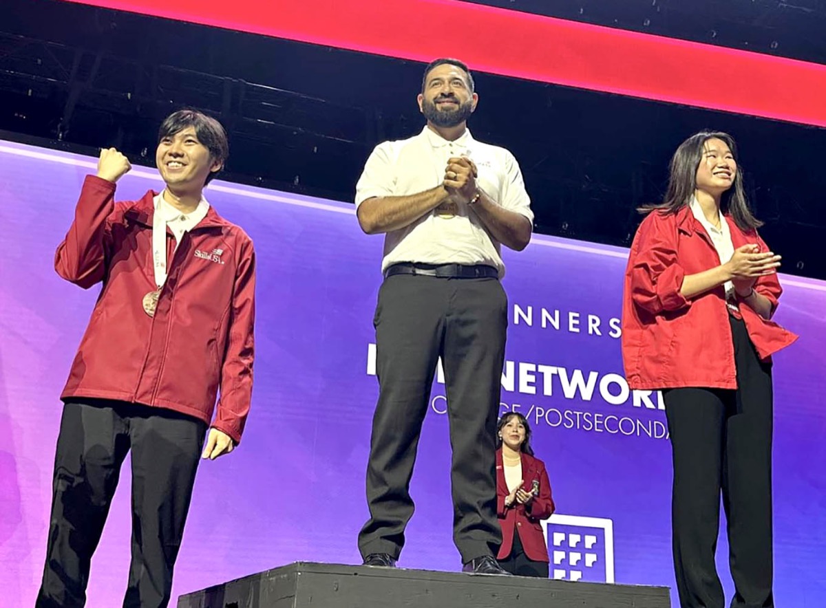 Click to enlarge,  Central Carolina Community College student Rosalio Avalos (center) is pictured receiving his gold medal for Internetworking at the recent SkillsUSA national championships in Atlanta, Ga. 