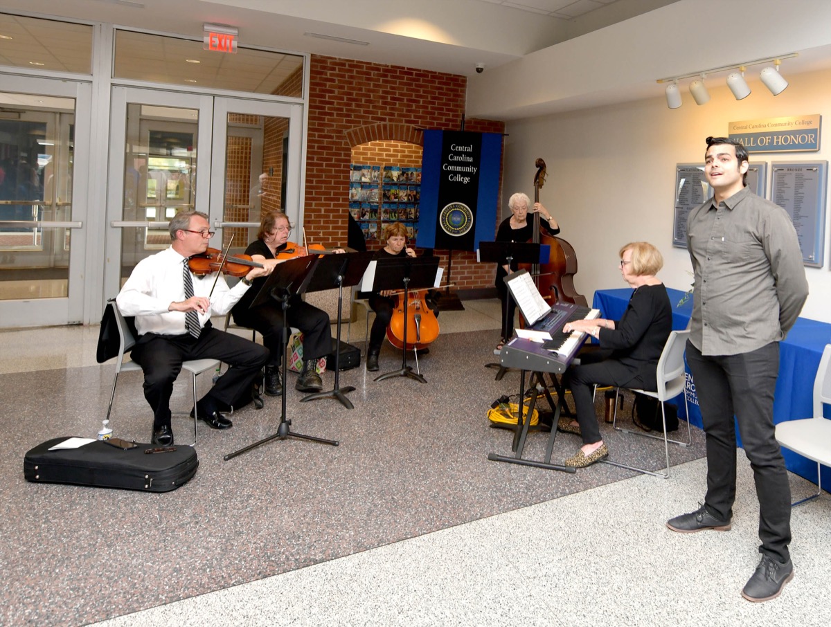 Click to enlarge,  Musicians for the CCCC Veterans Day commemoration were Vocalist Jacob Barton and members of the Lee County Community Orchestra. 