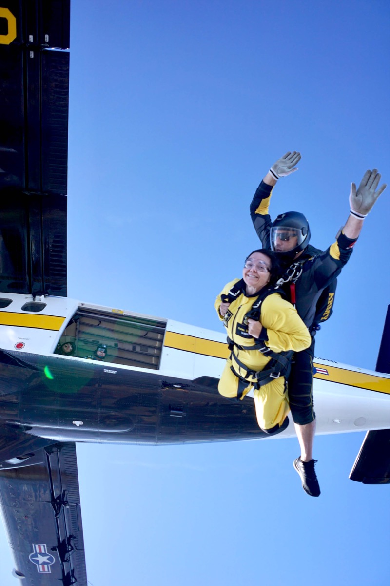 Click to enlarge,  Dr. Sara Newcomb, Central Carolina Community College Executive Director of Secondary Partnerships, is all smiles after jumping out of a plane with U.S. Army Golden Knight Sergeant First Class Ryan Reis in a tandem skydive. 